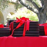 stacks of diplomas tied with red ribbons for Commencement