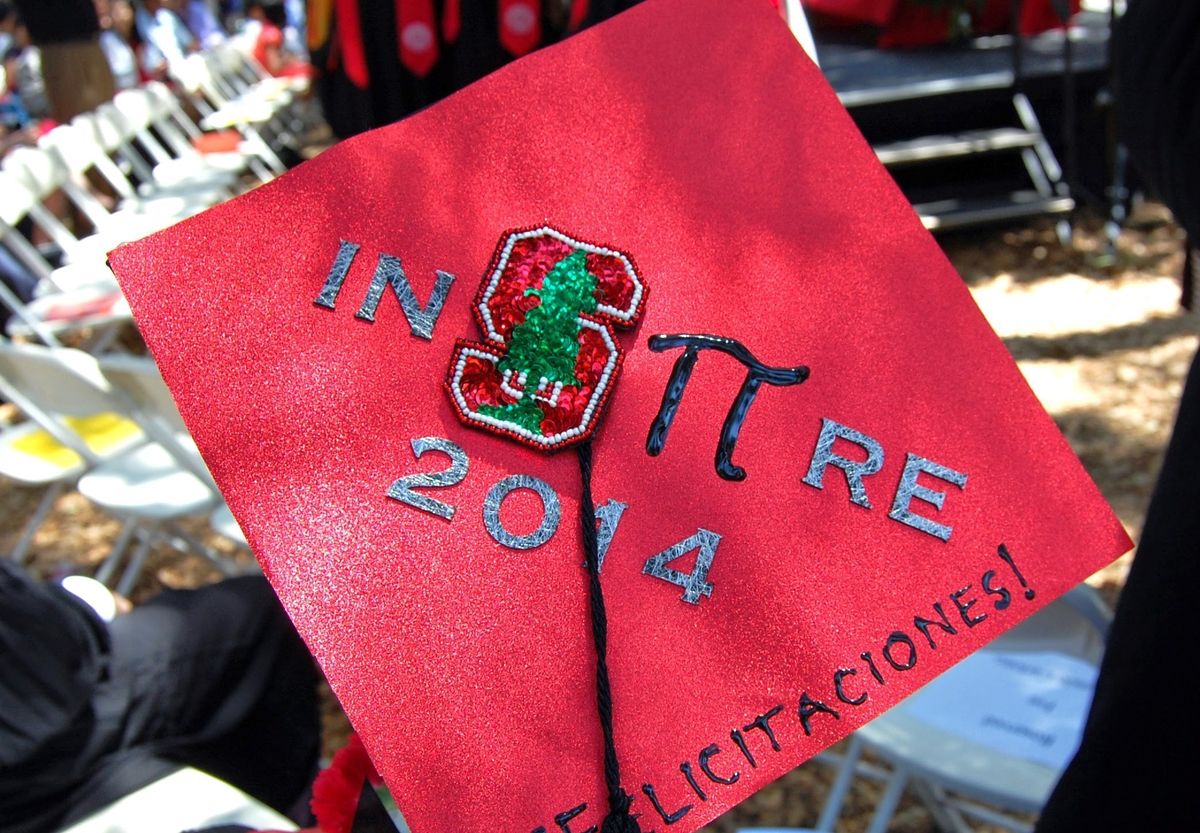 a red mortarboard decorated for Commencement